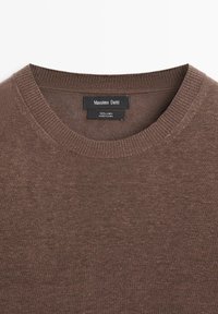 Pull en lin brun à col rond avec col côtelé, portant une étiquette Massimo Dutti et une étiquette de taille à l'intérieur du col.