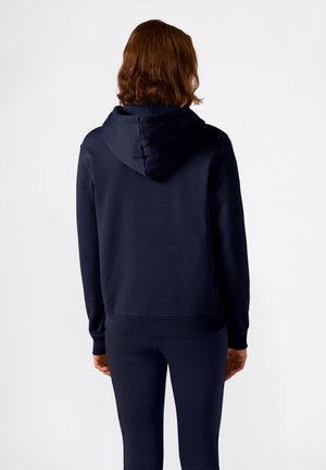 Marineblauwe hooded sweatshirt met geribbelde manchetten en zoom, gemaakt van zachte stof, gezien van de achterkant, gedragen met bijpassende leggings.