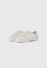 Light gray sneakers with a smooth texture, designed with a white sole and unique cut-out accents. Features laces and ventilation holes.