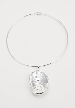 Silver necklace with a large shell pendant, featuring smooth, reflective surfaces and intricate texturing. Simple round chain design.