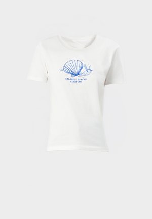 White cotton t-shirt with short sleeves, featuring a blue shell graphic and text "SEASHELL SEEKER SINCE 1996" centered on the front.