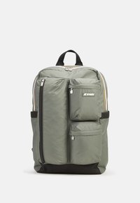 Zaino verde in nylon con due tasche frontali con zip, fondo nero e spallacci imbottiti. Presenta un manico superiore e un dettaglio con logo.