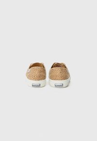 Leopard print canvas sneakers with a round toe, white rubber soles, and a Superga logo on the heel and side panels.