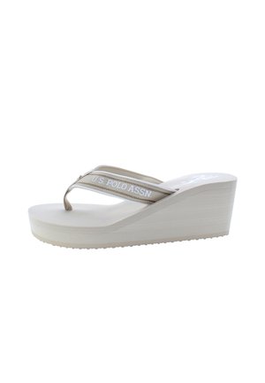 Infradito beige con zeppa, suola texturizzata, fasce con logo e footbed piatto, progettate con una piattaforma inclinata per elevazione.
