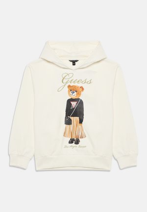 Hoodie in Cremefarbe mit Bärenmotiv, schwarzen Buchstaben und einem plissierten Rockdesign. Weicher Stoff mit geribbelten Bündchen und Saum.