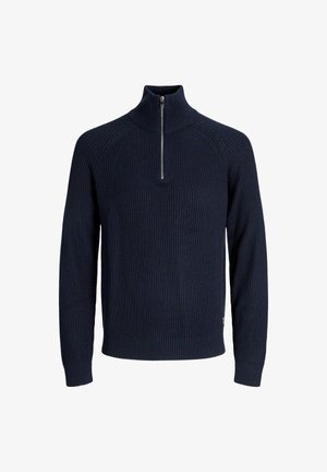 Tumes sinise värvi kudum, millel on kõrge kaelus ja pool tõmblukk. Omab soonikuid ja pikki varrukaid, pakkudes kitsast siluetti.