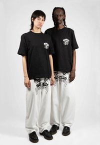 Wasted Paris CASPER PANT UNLEASHED UNISEX - Platūs džinsai - off white