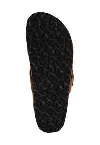 Brown sandal with a textured black rubber sole featuring a circular pattern, showing a sturdy design and supportive grip.