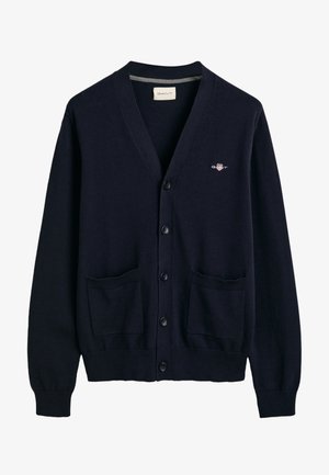 Cardigan blu navy realizzato in morbido tessuto, caratterizzato da scollatura a V, chiusura con bottoni sul davanti, due tasche frontali e un piccolo logo sul petto.