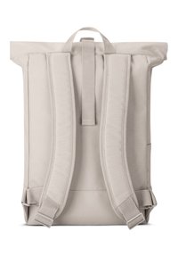 Light gray backpack with a roll-top design, adjustable padded straps, minimalist style, reinforced seams, and silver metal hardware.