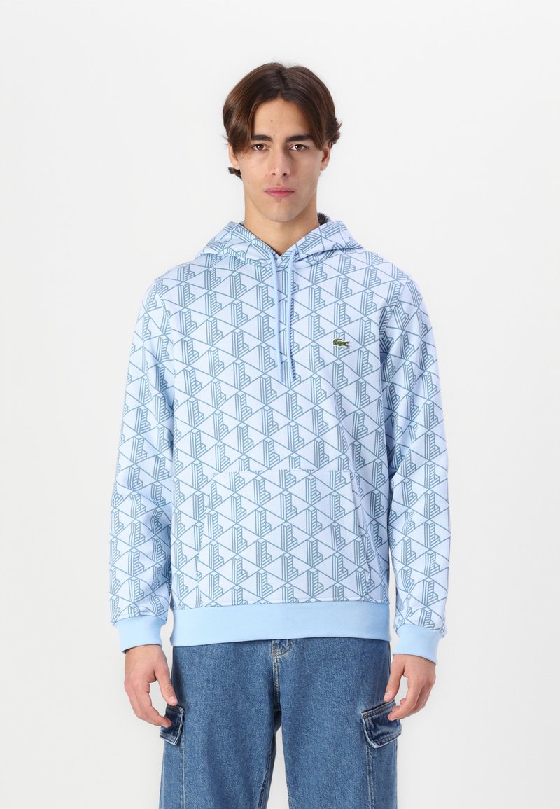 Felpa leggera blu chiaro con motivo geometrico in blu scuro, con tasca frontale, cappuccio con cordoncino e polsini e orlo a coste.