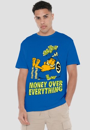 Blue cotton t-shirt featuring a graphic of a cartoon cat with dollar bills and the text "MONEY OVER EVERYTHING" in a bright green font.