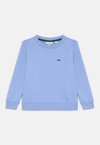 Felpa a maniche lunghe azzurro chiaro con collo a giro e polsini e orlo a costine, caratterizzata da un piccolo logo verde del coccodrillo Lacoste sul petto.