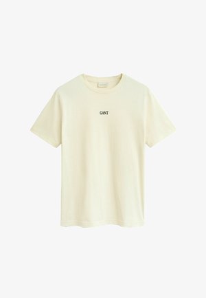 T-shirt beige à manches courtes, col rond, avec un petit logo noir "GANT" centré sur la poitrine.
