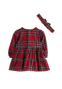 Rotes karieriertes Kleid mit langen Ärmeln, schwingendem Rock und Knopfverschluss hinten. Inklusive passendem kariertem Haarband.