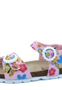 Sandale rose avec motifs floraux, semelle en liège, accents blancs et sangle réglable. Dispose d'une semelle texturée pour une meilleure adhérence.