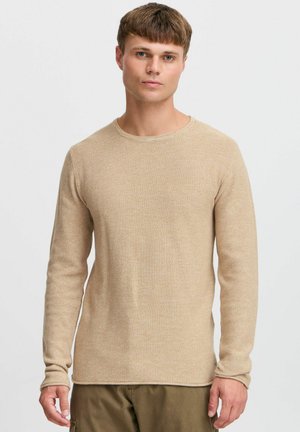 Beige textured knit sweater with a crew neckline and long sleeves, featuring a subtle pattern and a straight hem.