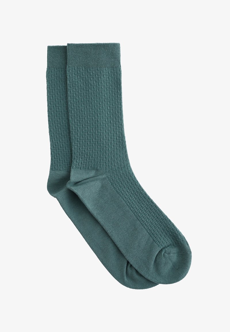 Tealsed meeskonnasokid, millel on säärtel tekstuuriga siksakmuster ning jalalaba ja varvaste piirkonnas sile kangas.