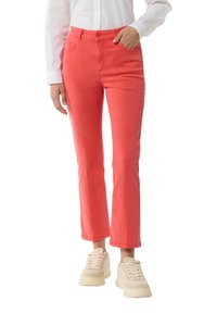 Coral cotton pants with a slim fit, mid-rise waist, and five-pocket styling. Features a subtle texture and stitched detailing.