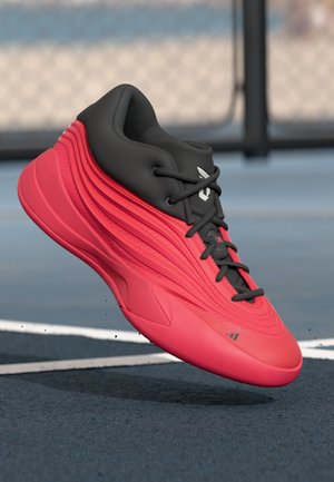 Red and black athletic shoe featuring a sleek, textured design, rounded toe, and raised lines along the sides, with black laces and logo.