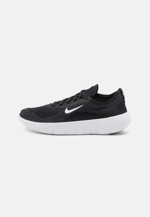 Nike running shoes with black mesh upper, white rubber outsole, and textured detail. Features a curved sole and flat laces.