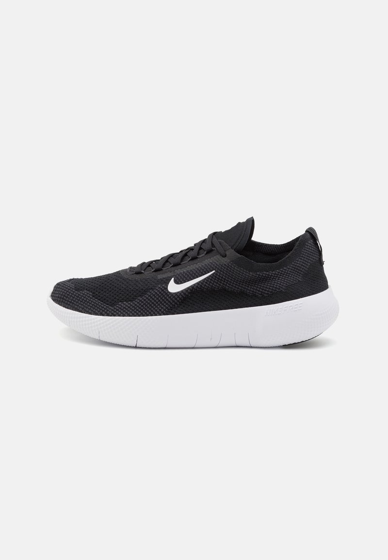 Nike löparskor med svart nätövre, vit gummisula och texturerad detalj. Har en kurvad sula och platta snören.