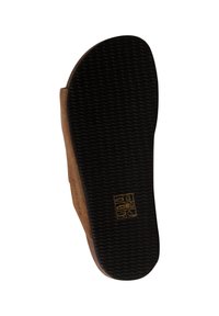 Sole di scarpa marrone con una base in gomma nera testurizzata, caratterizzata da una serie di simboli in rilievo per le istruzioni di cura e materiali.