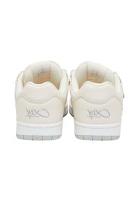 Kremfargede sneakers med myk lærtekstur, med hvite gummisåler og preget logodetaljer på hælen.