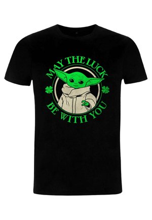 Černé tričko s zelenou grafikou postavy s velkýma ušima, obklopené textem "AŤ JE ŠTĚSTÍ S VÁMI" a znaky trojlístku.