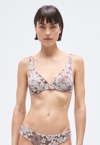 Brown floral-patterned bikini set featuring a triangular bralette with wide straps and a matching low-rise bottom. Smooth fabric texture.