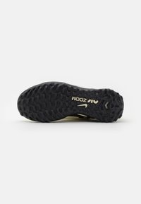 Black rubber outsole with textured grip pattern; features "Zoom" branding and a slight curve, designed for traction in athletic use.