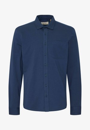 Temno modra srajca z dolgimi rokavi iz mehkega blaga, z gumbom spredaj, ovratnikom in enim žepom na prsih.