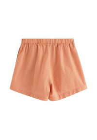 Orangemönstrade shorts med elastisk midja. Tyget har ett litet rutmönster och en mjuk textur. Inga fickor eller detaljer.