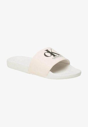 Chanclas de Calvin Klein en rosa pálido con una tira ancha que presenta un logo negro. La suela es blanca y está hecha de un material suave.