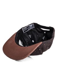 Brown-brimmed cap with a black speckled fabric. Inside features a dark lining and visible hardware. Includes brand tag and ventilation holes.