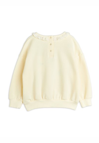 Sweatshirt crème avec un col en dentelle texturé, patte de boutonnage, poignets et ourlet côtelés. Tissu doux avec une coupe décontractée.