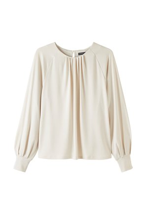 Beige bluse med rund halsudskæring, lange puffærmer og plisseret front. Lavet af glat stof, med indsamlet detaljering langs halsudskæringen.