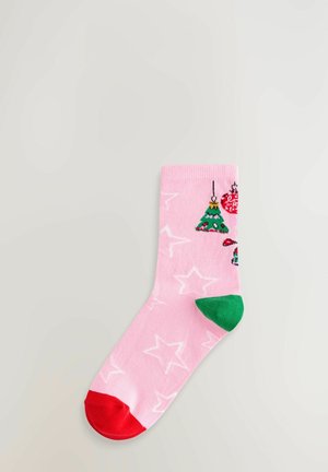 Pink sock with white stars, green heel, red toe, and Christmas-themed decorations including a tree and ornaments near the cuff.