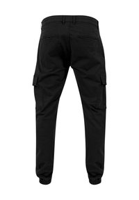 Pantalon cargo noir avec poignets élastiques, passants de ceinture, deux poches arrière et poches latérales à rabats, vu de dos sur fond blanc.