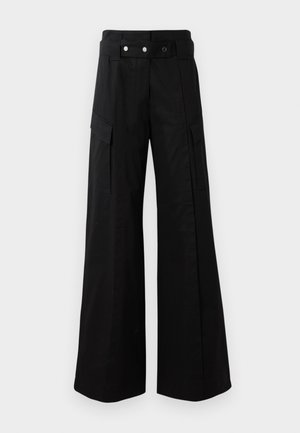 Black wide-leg pants with a high waistband, featuring large side pockets, two front buttons, and a loop detail. Made from sturdy fabric.