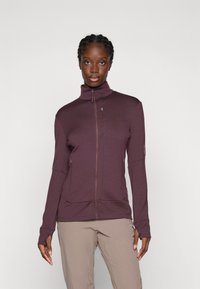 Giacca a zip bordeaux con colletto alto, maniche lunghe e cuciture piatte. Presenta due tasche con zip e un tessuto texturizzato per il calore.
