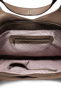 Brown leather tote bag interior, featuring a zippered pocket and a light pink lining with repeated branding design. Smooth texture, spacious.