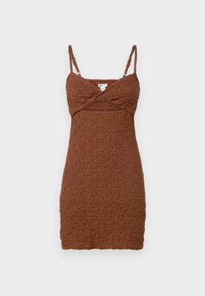 Vaatteetrusluisuinen, teksturoitu mini-mekko, jossa on säädettävät spagettiolkaimet ja ristikkäinen vartalo. Valmistettu ryppyisestä materiaalista, joka omaa istuvan siluetin.