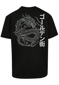 Black cotton t-shirt featuring a white dragon graphic and Japanese text design. Short sleeves, crew neck, casual fit.
