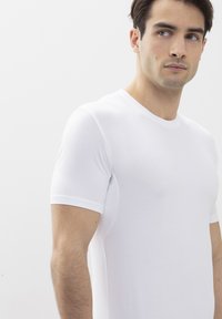 White short-sleeve t-shirt made from smooth cotton, featuring a crew neckline and fitted design. No patterns or accents visible.
