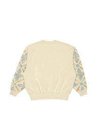 Sudadera cremosa de manga larga. Los detalles de las mangas presentan un patrón floral en azul, dorado y beige. Con puños y dobladillo acanalados.