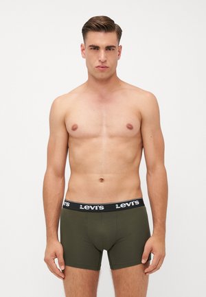 Boxers ajustados de algodón verde con una cinturilla negra que presenta el logo blanco de "Levi's". Diseñados para un ajuste ceñido, destacan por sus costuras mínimas y textura suave.