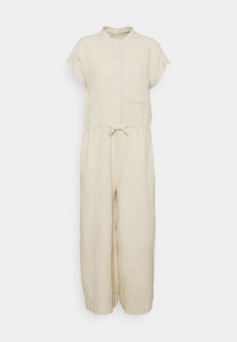 Combinaison beige à manches courtes avec boutons sur le devant, une poche poitrine, une taille à cordon et des jambes larges.