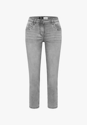 Jean en denim gris clair avec bouton et fermeture éclair à l'avant, style cinq poches, coupe slim, étiquette "Cecil Denim" à l'intérieur de la ceinture.