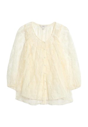 Top de encaje con mangas cortas abullonadas, color crema, que presenta bordados florales, cierre de botones en la parte delantera y un escote redondeado con un cuerpo fruncido.